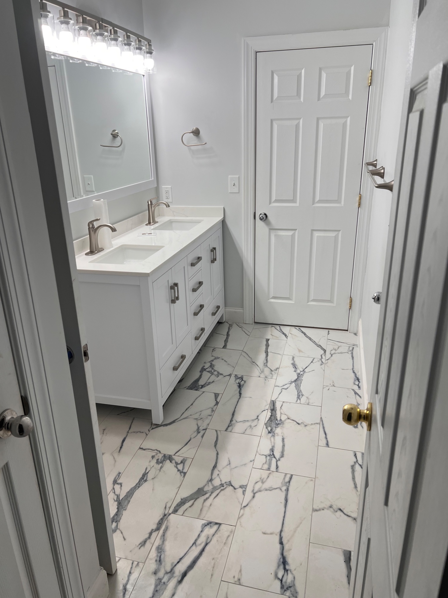New tile, vanity, light fixtures, mirror, and paint