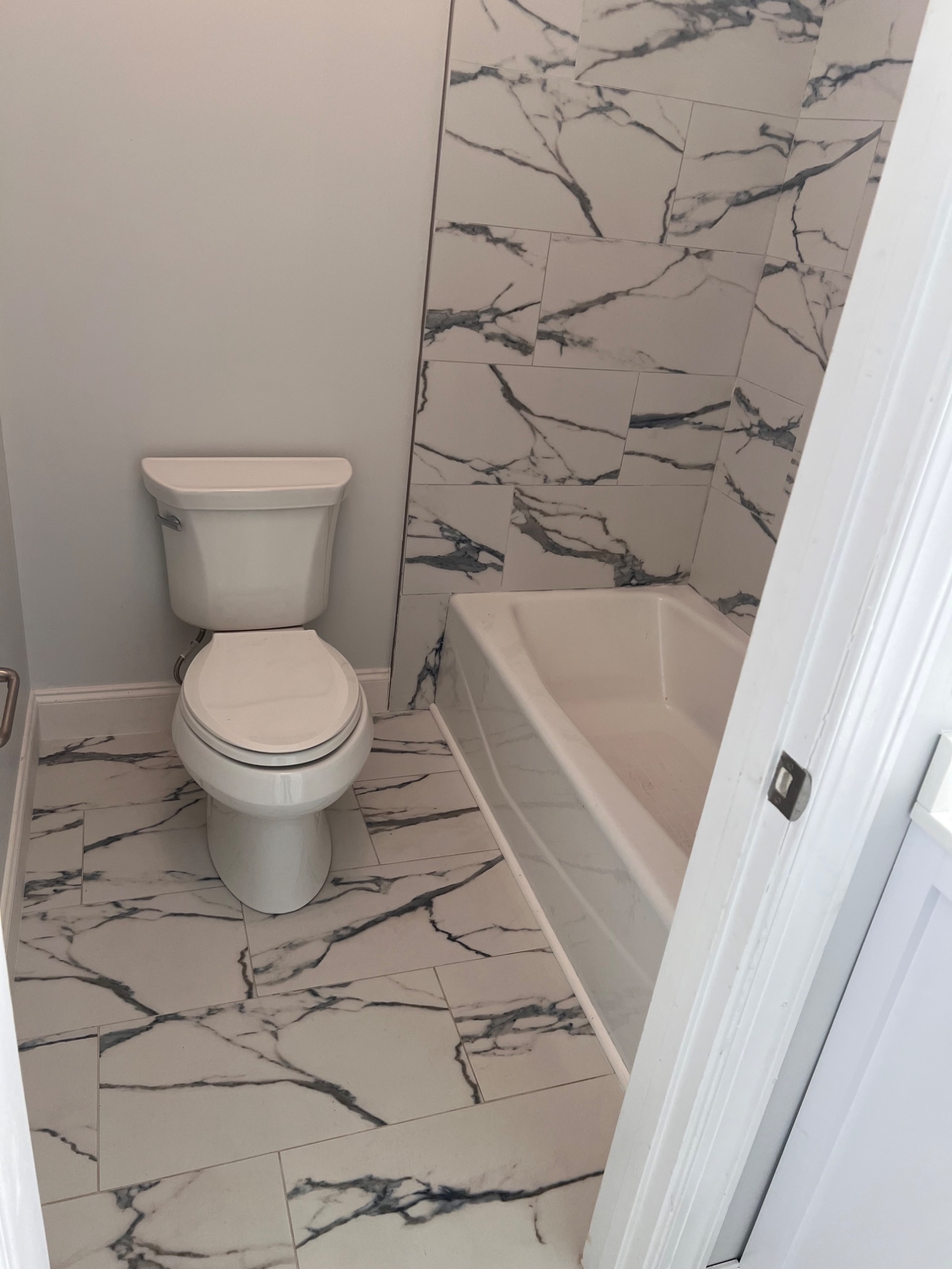 New Tile flooring, tile around shower, and toilet installation
